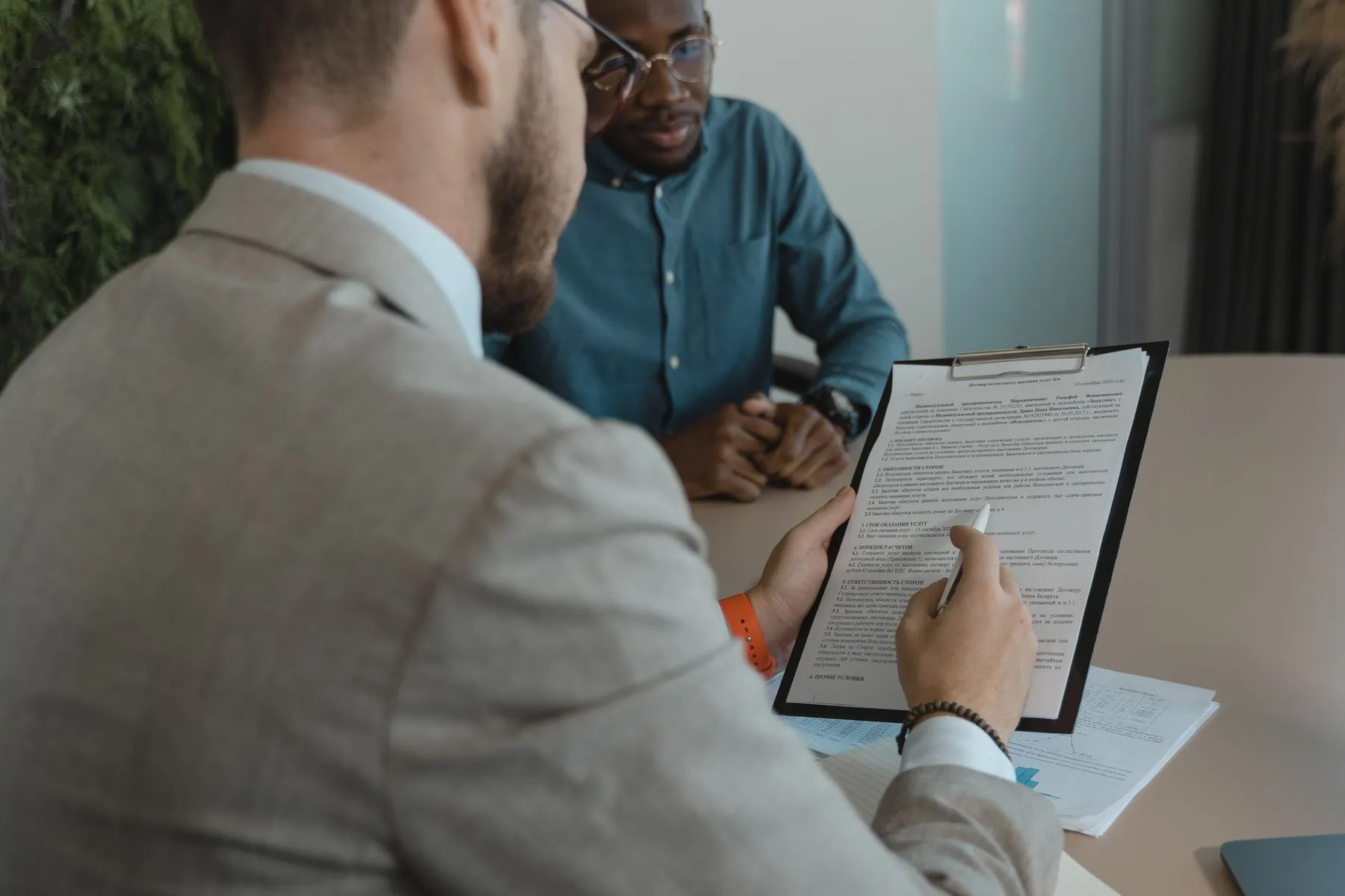 A recruiter reviewing a candidate's documents across a desk